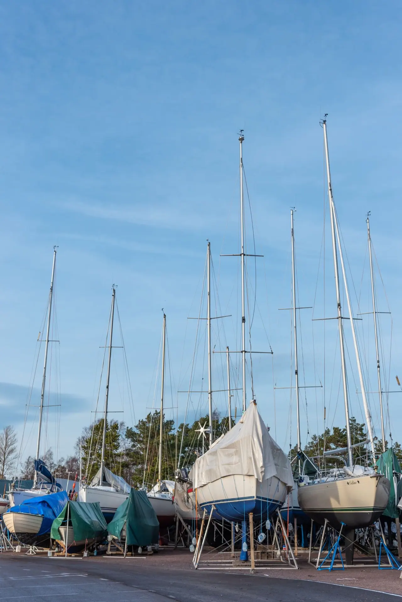Sailboats standing on steel cradles in a boatyard