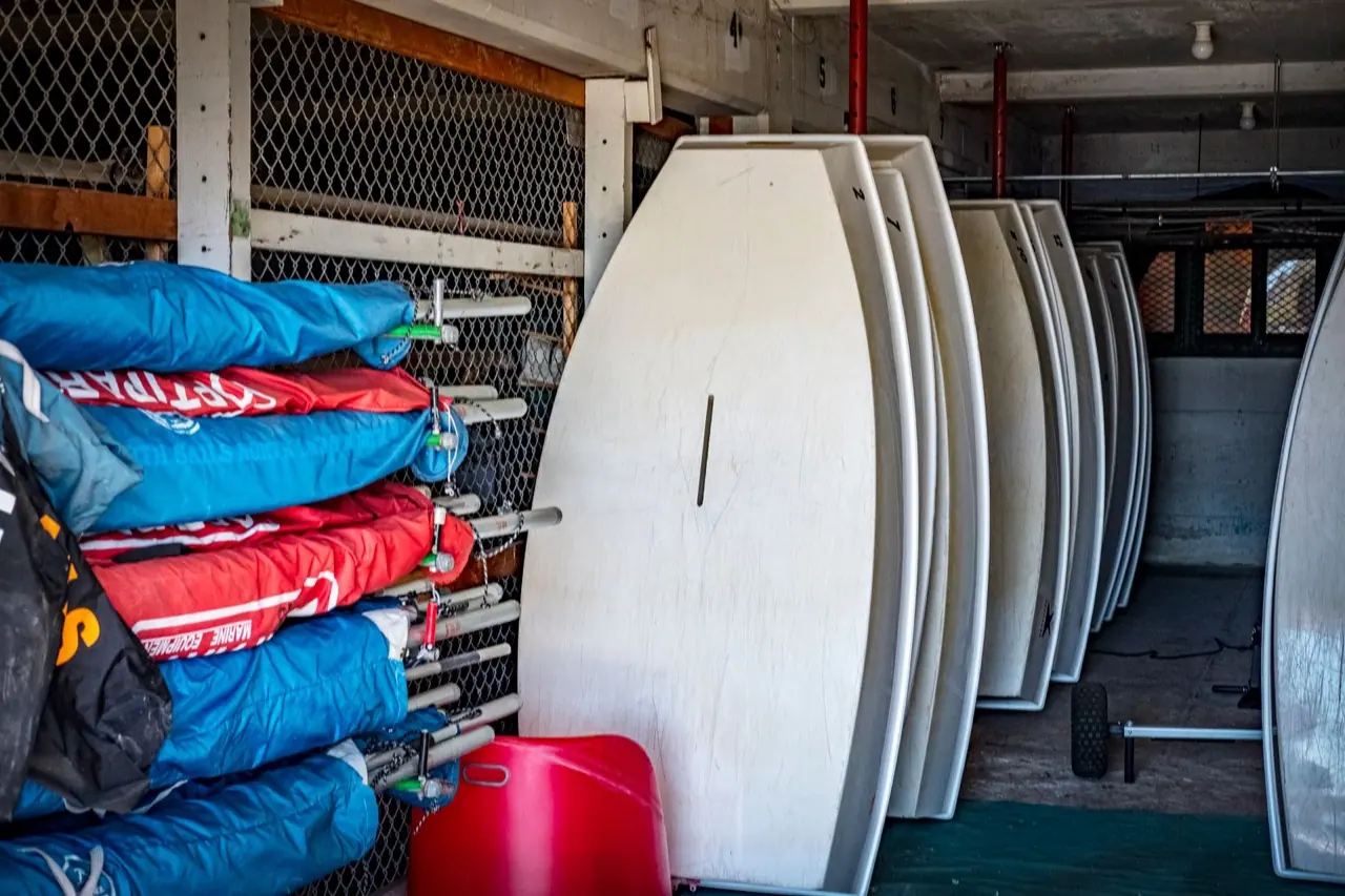 Sailboat hulls stored inside a large indoor storage building